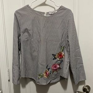 Long sleeve Black and white striped top with a floral design on the side